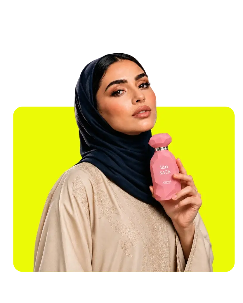 Alkhaleej Scents Löp Safa Arabian Prestige perfume for women featuring a pink fragrance bottle held by a woman wearing a black hijab.